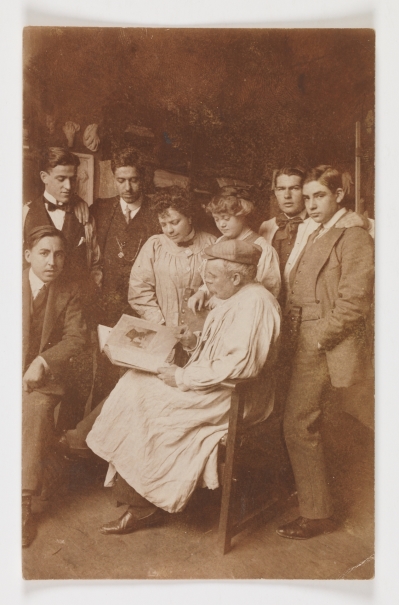 Image of the artwork: "Cecilio Pla Leafing Through a Book of the Caprichos with his Pupils"